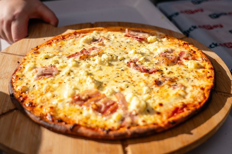 A freshly baked pizza served on a wooden board