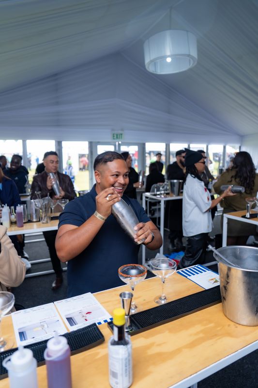 A guest shaking a cocktail in the Mixology Theatre