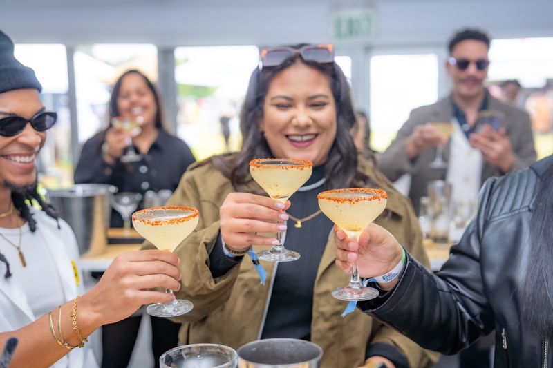 Guests toasting the cocktails they made in the Mixology Theatre